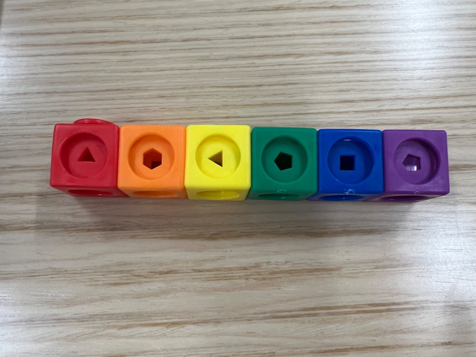A picture of one row of the previous set of Mathlink blocks. The set only has one of each color (column): red, orange, yellow, green, blue, and purple.