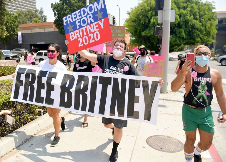 An image of protesters holding a 'Free Britney' sign and a 'Freedom for Britney 2020' sign. These signs represent the #FreeBritney movement, a social media campaign that advocated for Britney Spears to be released from her court-ordered conservatorship which had begun in 2008. The movement gained traction in 2019 and 2020, fueled by fan concerns about the conservatorship and its implications for Spears's well-being and autonomy. Ultimately, the movement played a significant role in raising awareness about the conservatorship and contributing to its eventual termination in 2021.