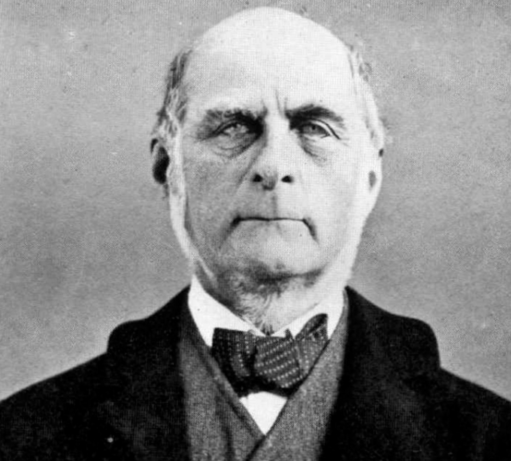 A picture of Francis Galton in a suit and tie. He is an old, unattractive man.