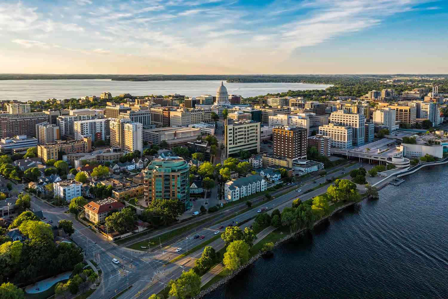 An ariel photo of Madison, Wisconsin. The image shows the two lakes to the north and south of Madison and the medium sized skyline of buildings.
